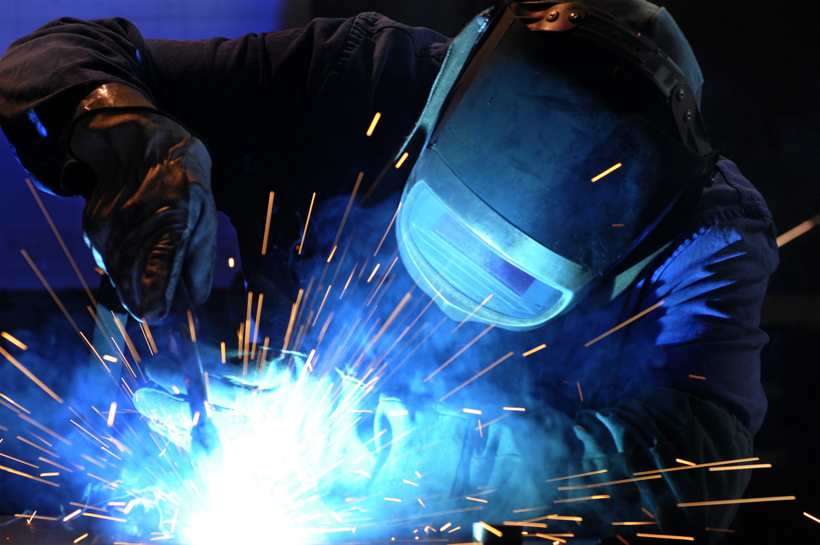 worker while doing a welding with arc welder